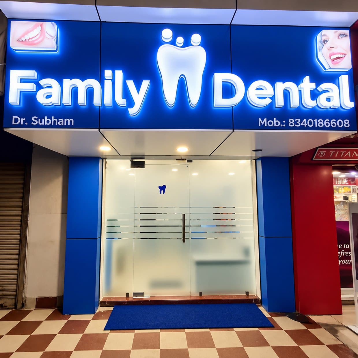 The lit Family Dental shopfront on the main road in Hirapur at night